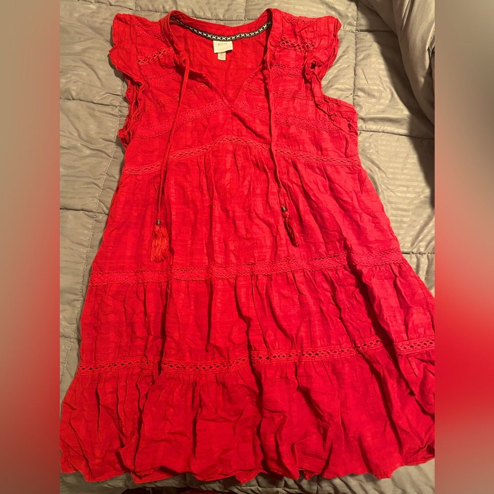 Red flouncy dress with stringed tassel’s at the neck of the dress to style